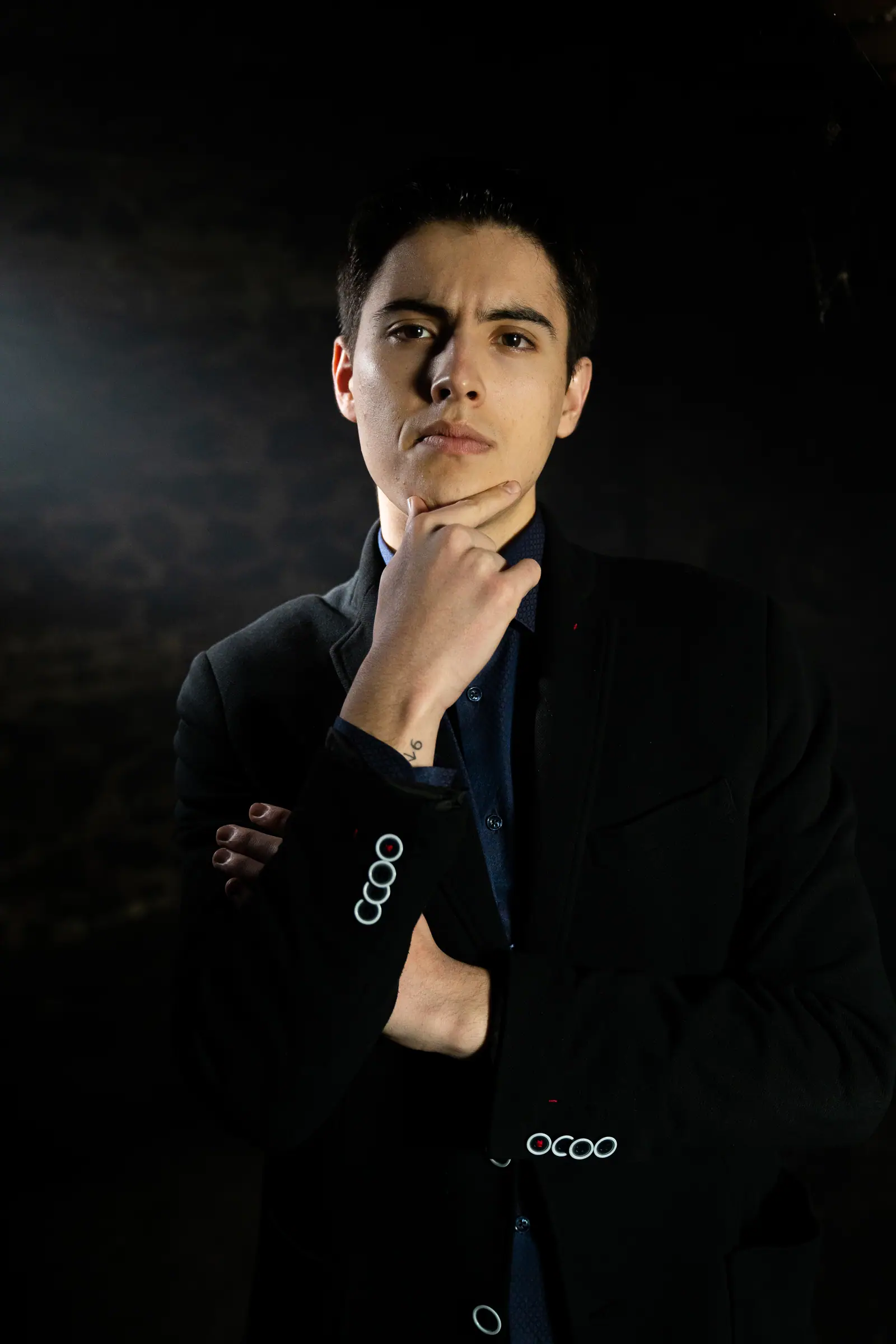 Rado Sheytanoff, hand to chin, holding a direct gaze.